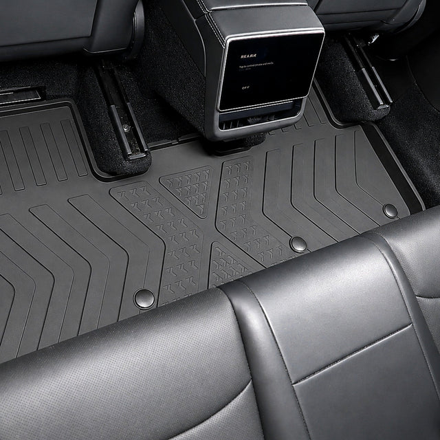MoldedFit second-row liner installed across the Tesla Model Y Juniper rear footwell